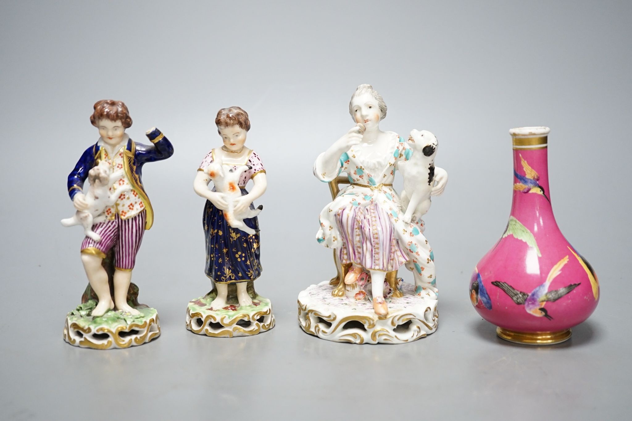 A Minton porcelain figure of a lady seated with a dog c.1830, a pair of Derby figures of a girl and a boy with a dog and a sheep, and a Bloor Derby vase